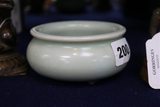 A Chinese Celadon glazed tripod censer
